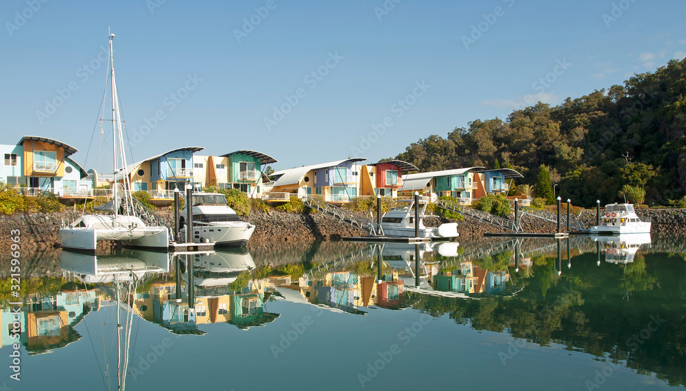  Waterfront marina/dock/resort with boats and clear water reflections.