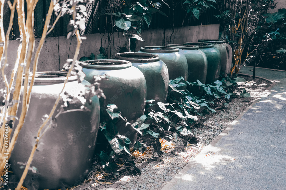 earthen water jar in garden. rain pot reservoir