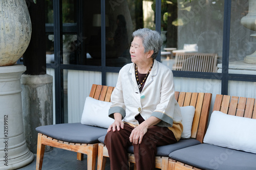 old elderly senior elder woman resting relaxing on terrace balcony