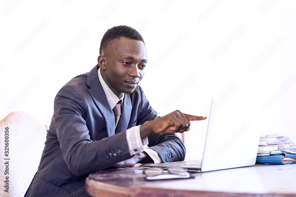 Actual handsome african american thinking ceo working in the office Actual handsome african american thinking ceo working in the office