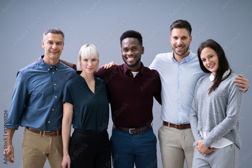 Group Of Smiling Businesspeople Standing In Office Group Of Smiling Businesspeople Standing In Office