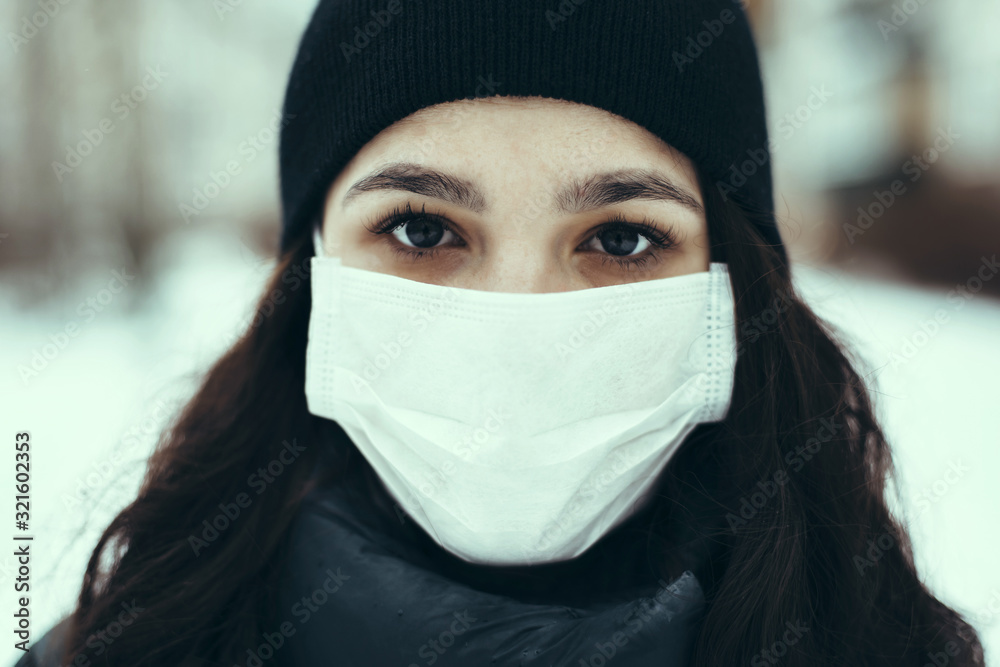 portrait of a sick Caucasian girl in a medical mask to protect against the virus during an epidemic portrait of a sick Caucasian girl in a medical mask to protect against the virus during an epidemic