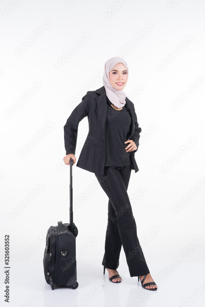 Muslim businesswoman in a hijab on a business trip with luggage isolated on white background. Suitable for cut out, manipulation or composite works for travel or business concept. Full length portrait Muslim businesswoman in a hijab on a business trip with luggage isolated on white background. Suitable for cut out, manipulation or composite works for travel or business concept. Full length portrait