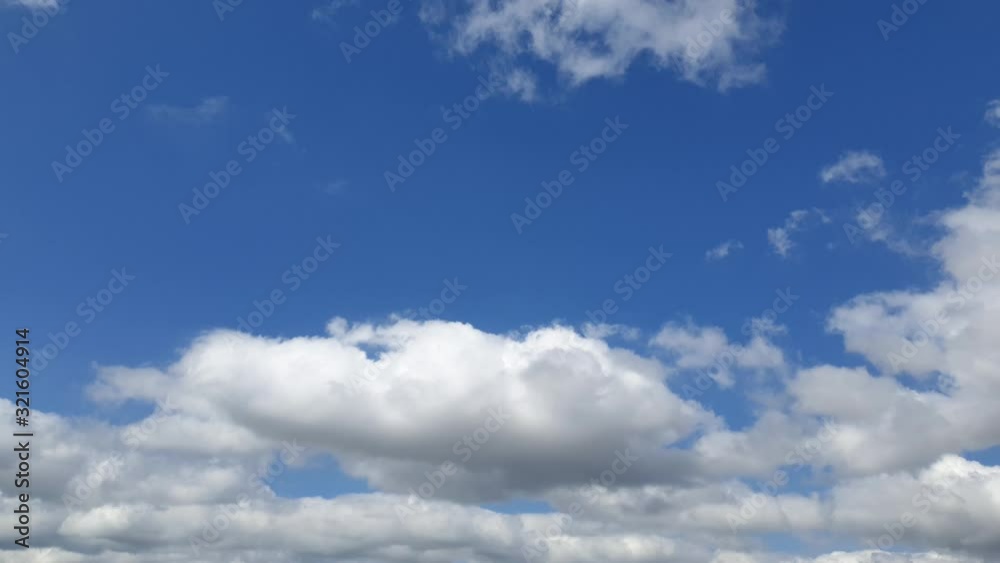 Beautiful blue summer sky with dense thick rain clouds moving across the horizon cloudscape time lapse