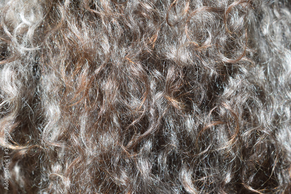 Sheep wool fur background. Dark brown texture. Thick soft curly brilliant hair. Close-up horizontal photography. Sheep wool fur background. Dark brown texture. Thick soft curly brilliant hair. Close-up horizontal photography.