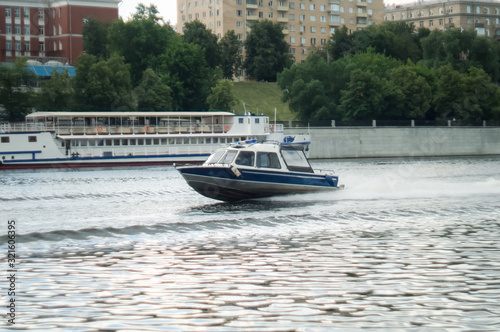 motorboat racing through the river. Fast motion river police on a motorboat