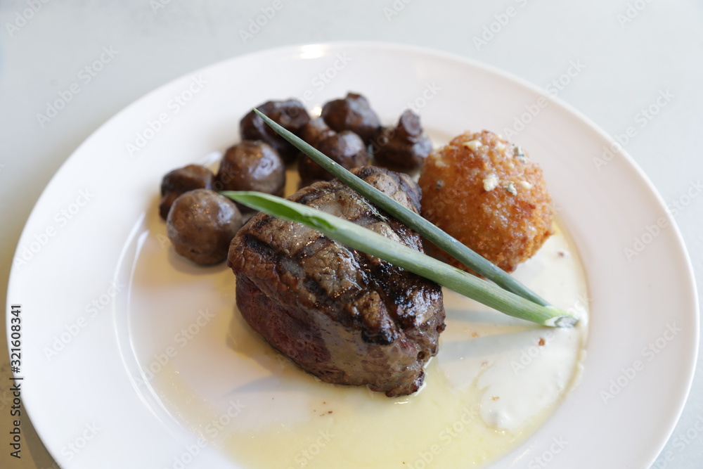 prime cut beef sirloin steak with sauteed mushrooms and hush puppy