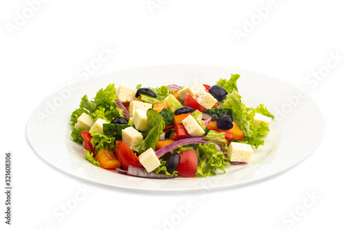 salad of different ingredients on a white plate on a wooden background