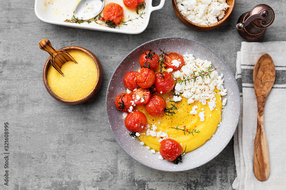 Homemade polenta with grilled cherry tomatoes and ricotta cheese.