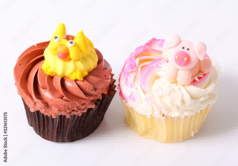 A colorful cupcake with doll on top , isolated A colorful cupcake with doll on top , isolated