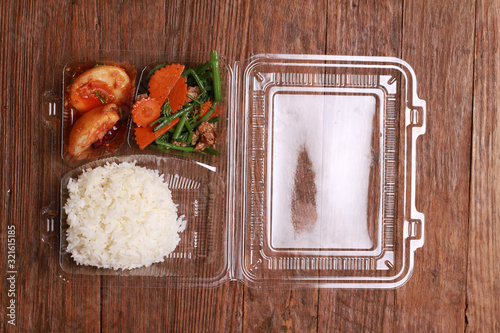 Thai package lunch to go on wood table.composition (top view). photo