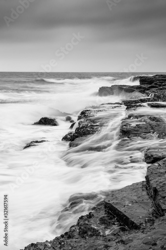 Seascape with water flowing across rocks