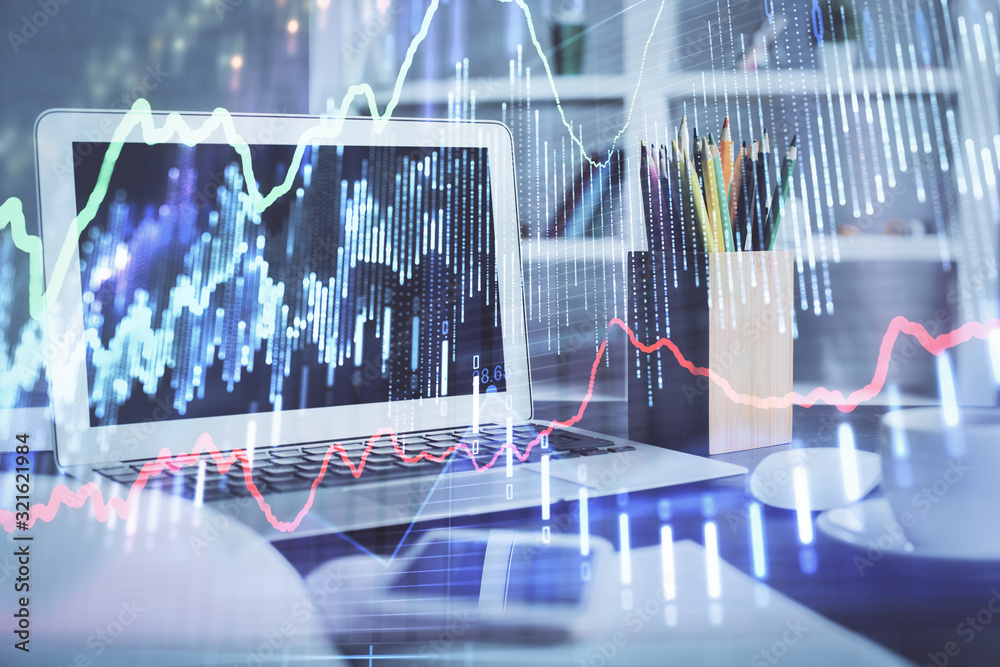 Stock market chart hologram drawn on personal computer background. Double exposure. Concept of investment. Stock market chart hologram drawn on personal computer background. Double exposure. Concept of investment.