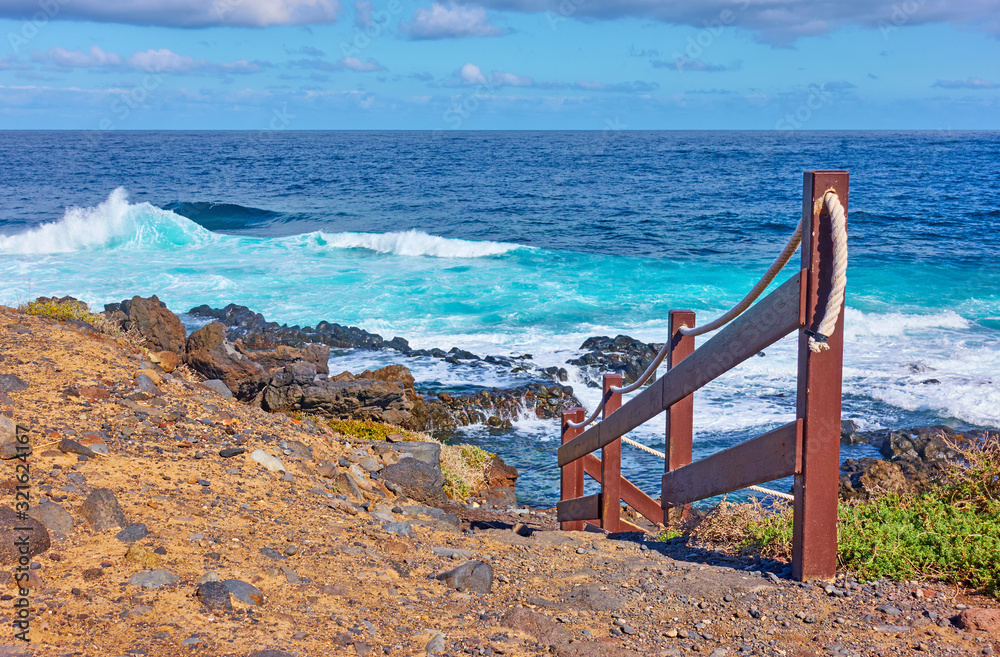Railed footpath on the coast of Tenerife by the sea Railed footpath on the coast of Tenerife by the sea
