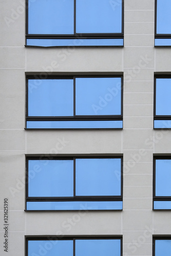 Fragment of the facade and windows of the office building as texture and pattern.