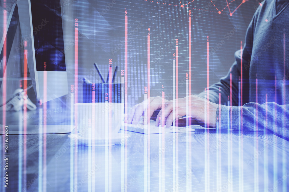 Multi exposure of graph with man typing on computer in office on background. Concept of hard work. Multi exposure of graph with man typing on computer in office on background. Concept of hard work.
