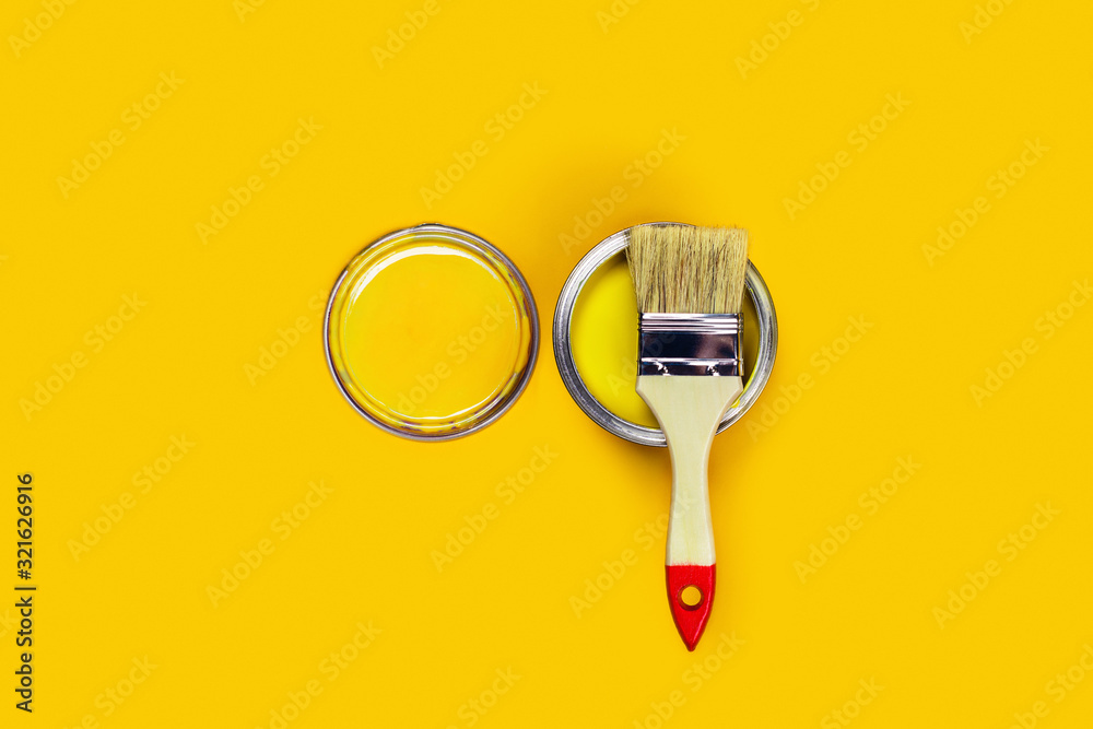 Renovation concept. Yellow background with one paint can and brush located on it. Flat lay, top view, copy space. Renovation concept. Yellow background with one paint can and brush located on it. Flat lay, top view, copy space.