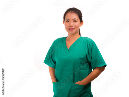 young beautiful and happy Asian Korean medicine doctor woman or hospital nurse in green scrubs posing cheerful smiling confident in corporate clinic staff portrait