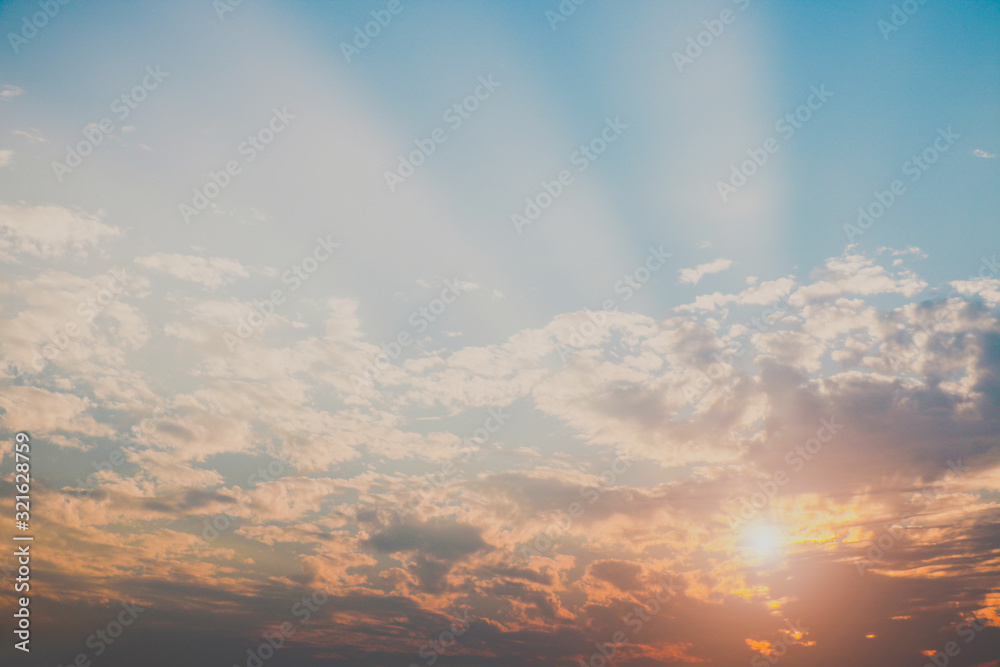 sky at sunset light penetrating with blue clouds tiny for texture background concept. sky at sunset light penetrating with blue clouds tiny for texture background concept.