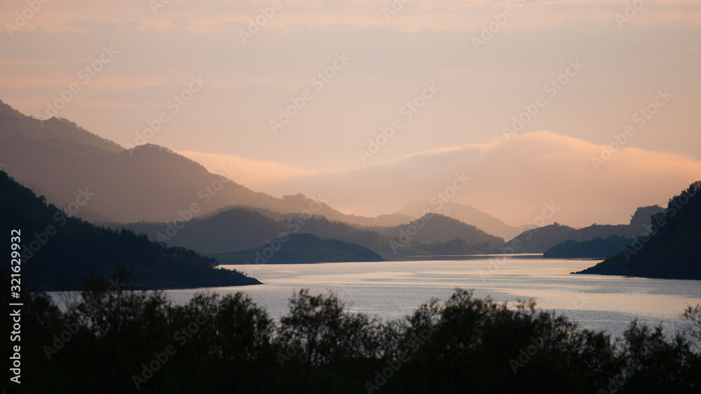 Beautiful sunset over lake and mountains, Norway..