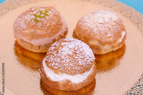 Custard cakes with cream on a blue background