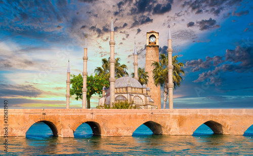 Sabanci Central Mosque, Old Clock Tower and Stone Bridge in Adana, city of Turkey. Adana City with mosque minarets in front of Seyhan river.