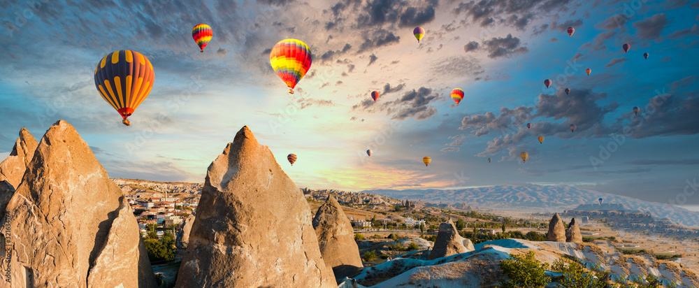 Colorful hot air balloons flying over at fairy chimneys in Nevsehir, Goreme,  Cappadocia Turkey. Hot air balloon flight at spectacular Cappadocia Turkey.  Stock Photo | Adobe Stock