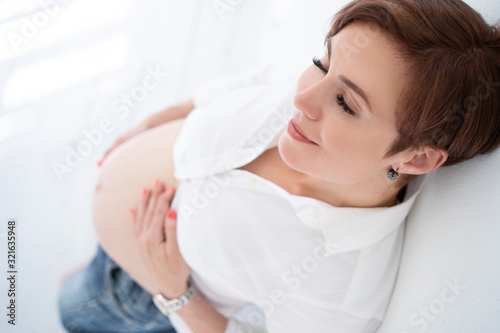 Stylish Woman Dreams Of Stroking Her Stomach In The Last Trimester Of Pregnancy