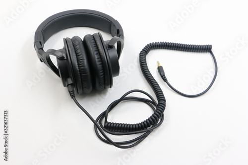 Headphones with attached coiled cable