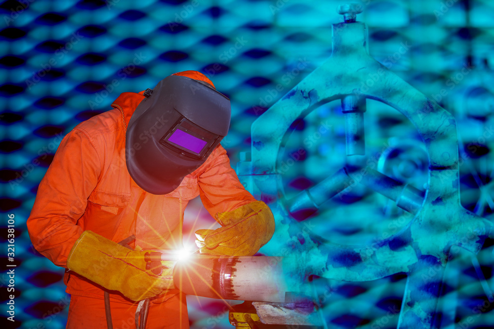 Naklejka premium Man welding process aluminum using tig handle, Industrial worker at factory welding close up.