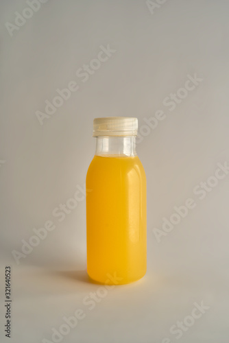 Orange bottle isolated on beige background