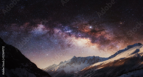Panorama of night sky full of stars with colorful Milky Way in the mountain. Nepal, Himalayas. © creativeforce