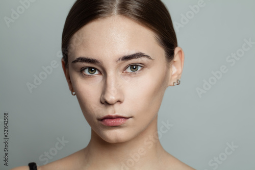 Young beautiful woman without makeup cosmetics portrait. Face closeup, real skin