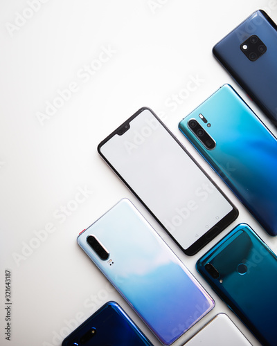 Colorful modern smartphones mockup isolated in white background. Blue, white and gold phones. photo