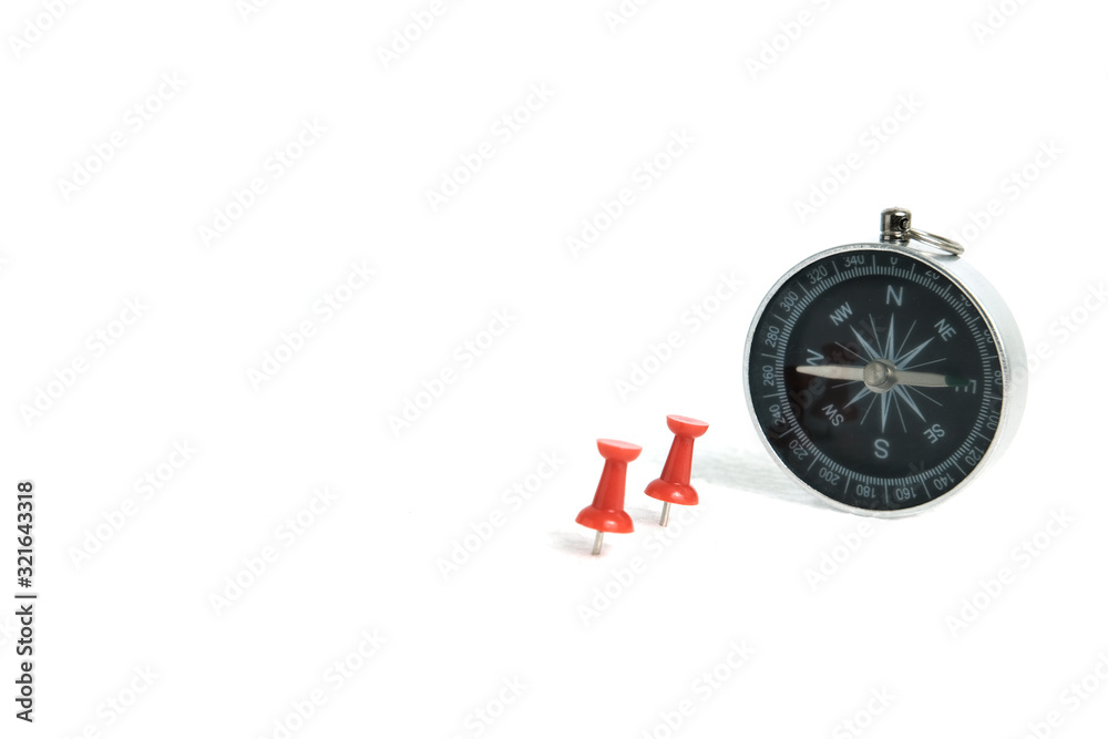 Two embedded red thumbtack / pushpin with compass isolated on white background Two embedded red thumbtack / pushpin with compass isolated on white background