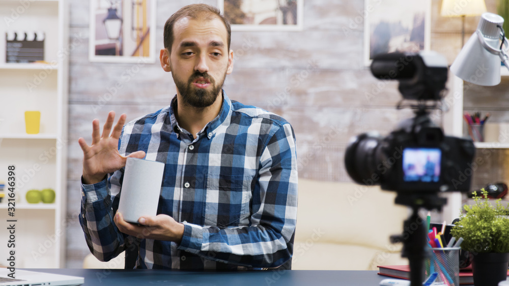 Fototapeta premium Famous vlogger filming smart speaker review for his followers