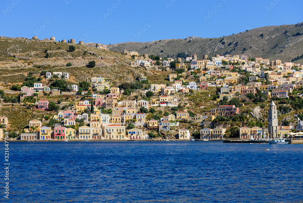 Sightseeing of Greece. The picturesque coastline of Symi island with beautiful old houses, Symi island, Dodecanese, Greece