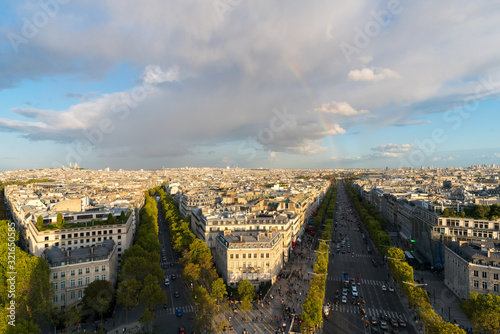 Aerial view of Paris City and the Avenue des Champs-Élysées with a rainbow among the city