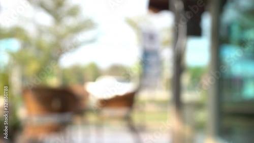 blur scene outdoor cafe with table seat outside garden view in the morning