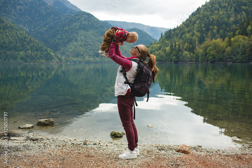 Mom and son walk by the lake