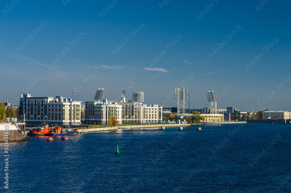 Sea panorama of the city with blue expanse of water, blue sky. Panorama of the historic city. View of the Petrovsky island of St. Petersburg and the old football stadium Sea panorama of the city with blue expanse of water, blue sky. Panorama of the historic city. View of the Petrovsky island of St. Petersburg and the old football stadium