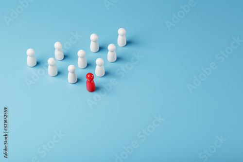 The leader in red leads a group of white employees to victory  HR  Staff recruitment. The concept of leadership.