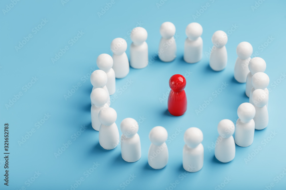 A team of white people stands around and listens to the leader of the red Leader. The concept of the leader of the business team. A team of white people stands around and listens to the leader of the red Leader. The concept of the leader of the business team.