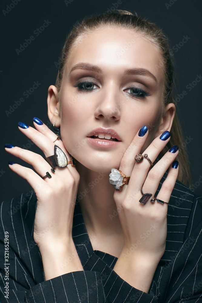 Young woman with many bijouterie rings with stones on fingers Young woman with many bijouterie rings with stones on fingers