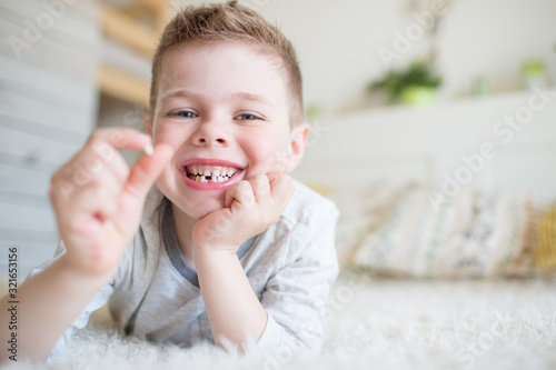 Teenager child with a tooth dropped out