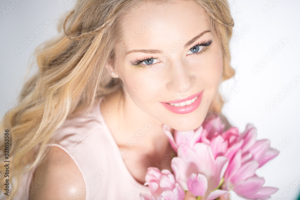 Luxurious blonde with a bouquet of tulips Luxurious blonde with a bouquet of tulips