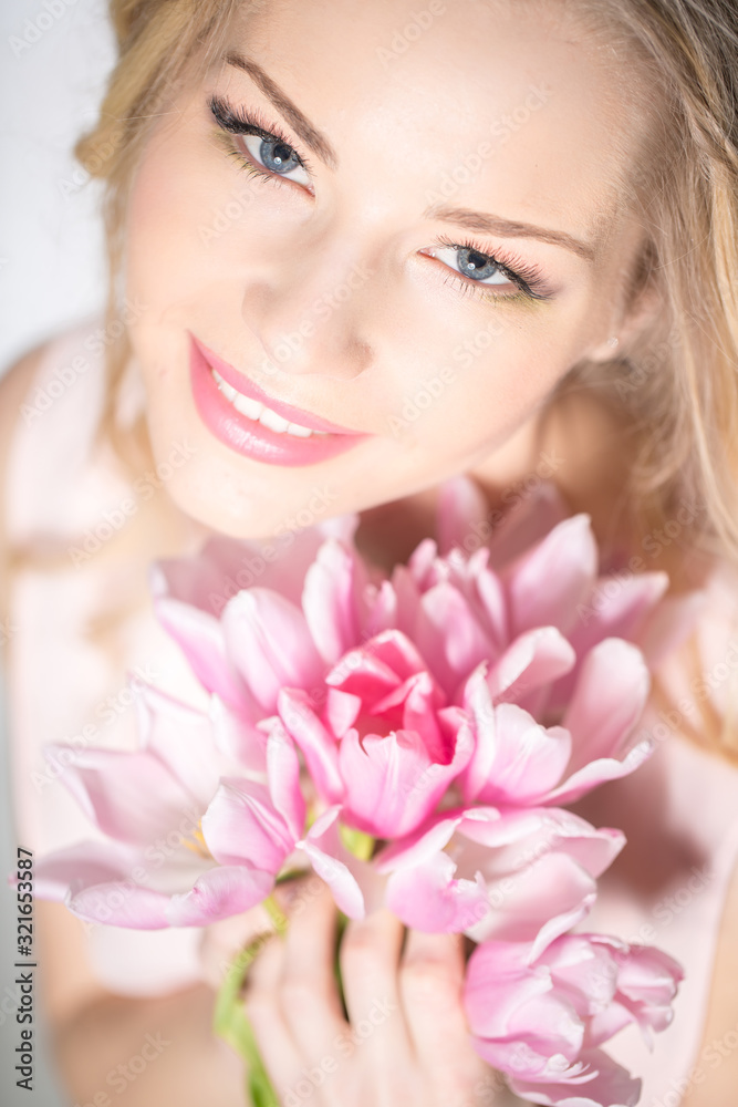 Luxurious blonde with a bouquet of tulips Luxurious blonde with a bouquet of tulips