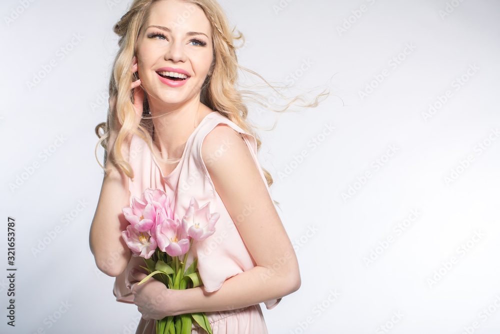 Luxurious blonde with a bouquet of tulips Luxurious blonde with a bouquet of tulips