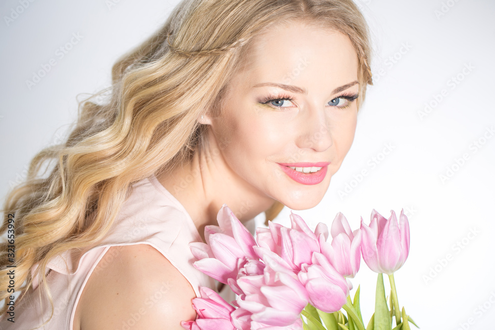 Luxurious blonde with a bouquet of tulips Luxurious blonde with a bouquet of tulips