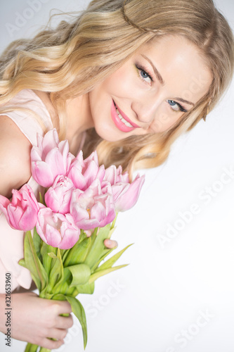 Luxurious blonde with a bouquet of tulips